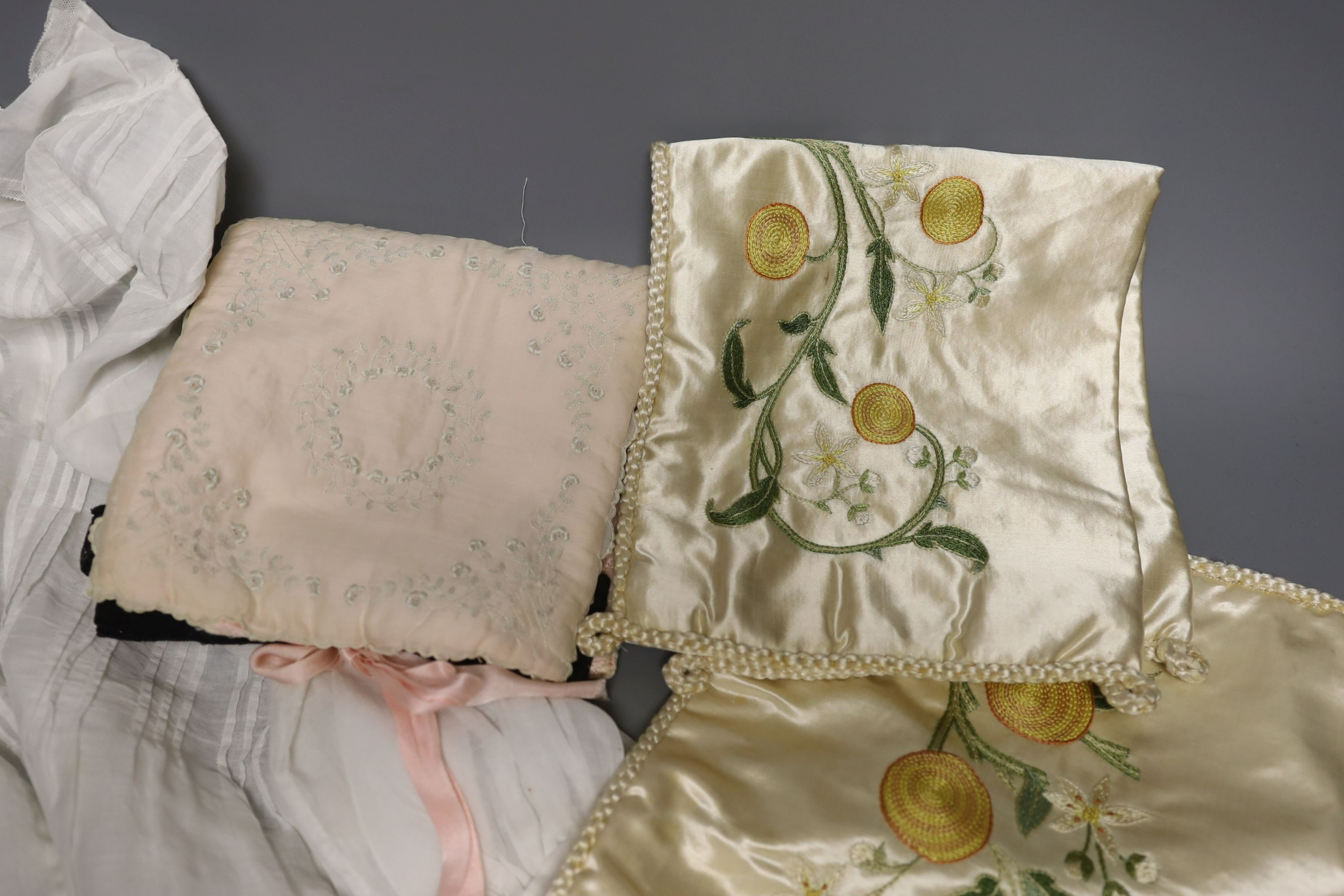 A pair of felt fur-lined child's boots and a whitework communion dress, a handkerchief sachet and two satin embroidered sachets